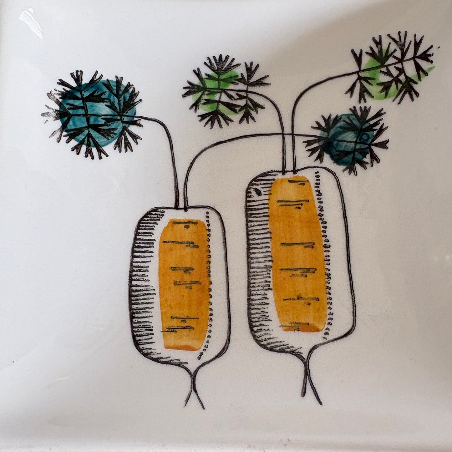 Hand-decorated root vegetable illustration inside Marianne Westman My Garden serving dish compartment