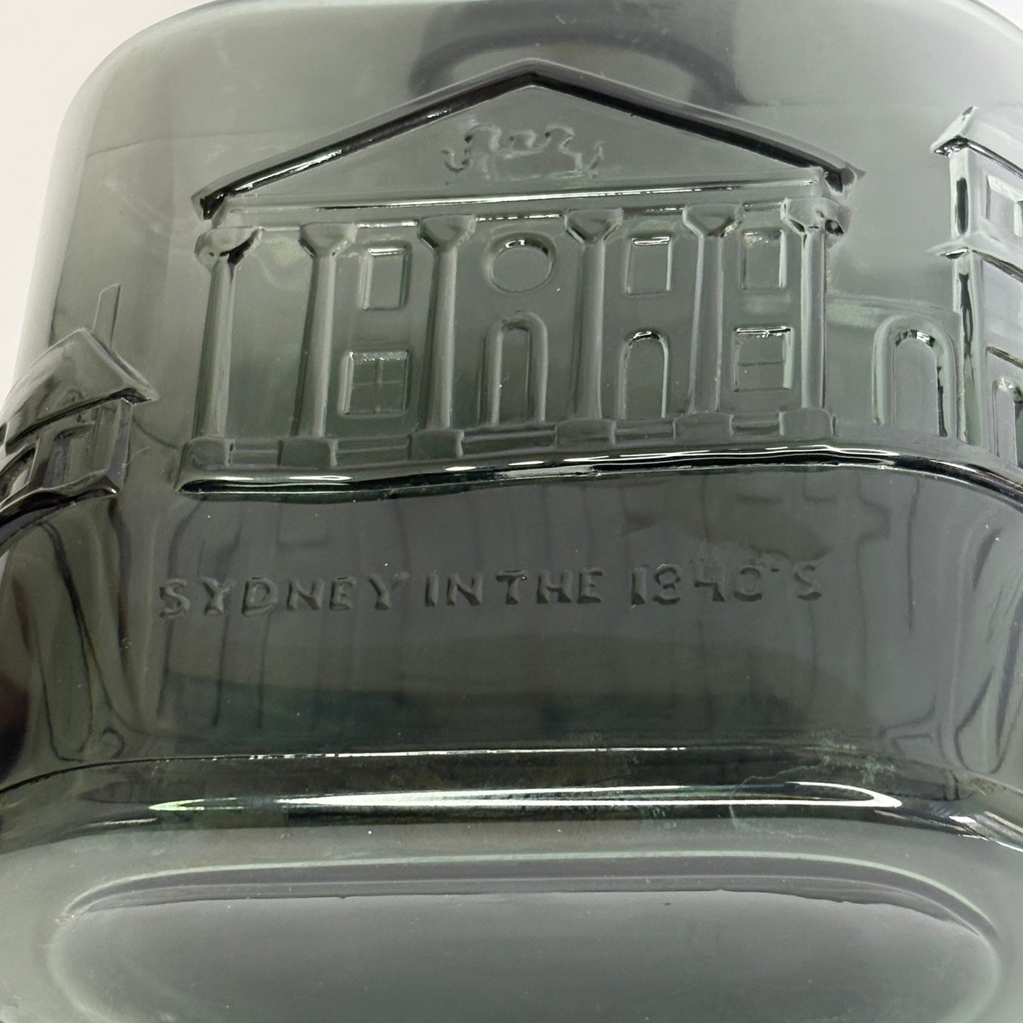 Three-quarter view of Nuutajärvi Notsjö decanter showing architectural embossed band and cork stopper