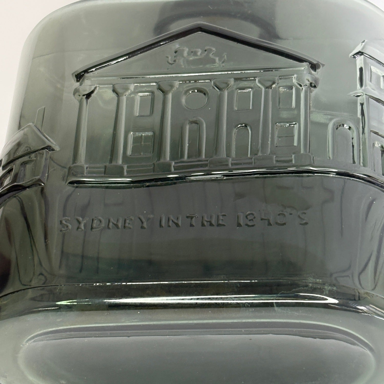 Three-quarter view of Nuutajärvi Notsjö decanter showing architectural embossed band and cork stopper