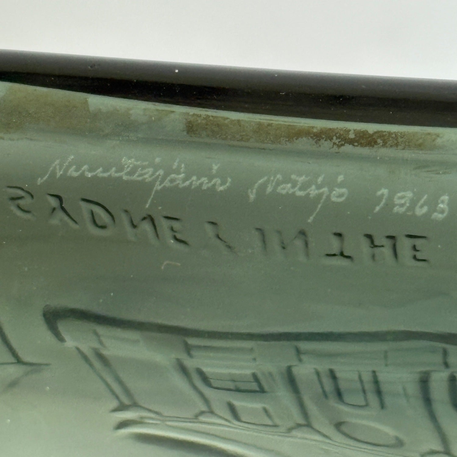 Close crop of laser wriiten signature and date marks inside base of Nuutajärvi decanter